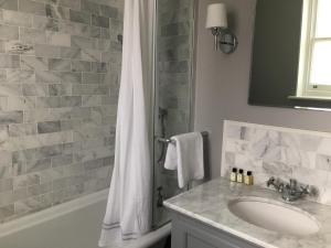 a bathroom with a sink and a shower at Balham Lodge in London