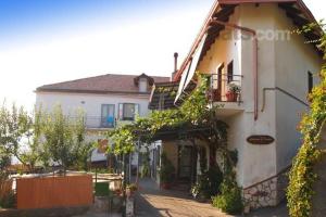 a large white house with plants on the side of it at Agriturismo Zì Carmine in Agerola
