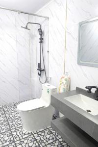 a bathroom with a toilet and a sink at Kingfisher Nest in Hai Phong