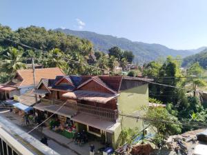 an overhead view of a building with mountains in the background at Khamfong Guesthouse in Pakbeng