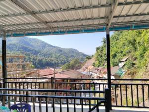 a view of a mountain village from a train station at Khamfong Guesthouse in Pakbeng +6 photos