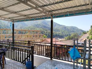 a balcony with a view of a mountain at Khamfong Guesthouse in Pakbeng