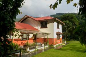 a house with a red roof and a yard at Burpeepal in Gangtok