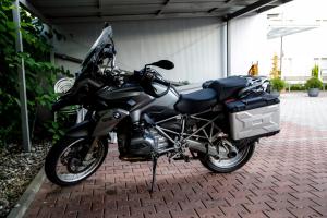 a motorcycle parked in front of a brick building at Hotel Tabor in Maribor