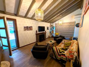 a living room with a couch and a fireplace at Ocean Drive Home: 3 bedroom 70s-inspired… - 19110 in Bunbury