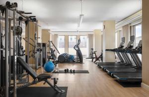a gym with a bunch of treadms and pilates equipment at Mokara Hotel & Spa in San Antonio