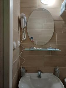 a bathroom with a sink and a mirror at Hotel Gostynnyi Dvir in Sharhorod +82 photos