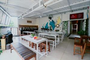 a restaurant with tables and chairs in a room at Hotel Safara Yogyakarta in Yogyakarta