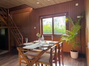a dining room with a table and a window at Jungle flare in Hampāpura