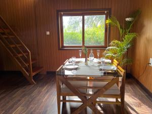 a dining room with a table and a window at Jungle flare in Hampāpura +58 photos