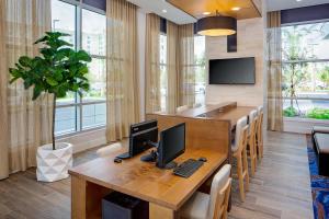 an office with a desk with two computers on it at Hyatt House across from Universal Orlando Resort in Orlando