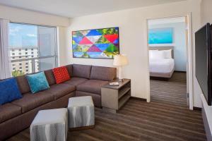 a living room with a couch and a bed at Hyatt House across from Universal Orlando Resort in Orlando +47 photos
