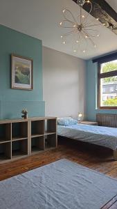 a bedroom with two beds and a ceiling fan at Charlemagne house in Liège