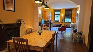 a dining room with a wooden table and chairs at Charlemagne house in Liège