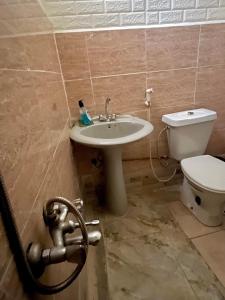 a bathroom with a sink and a toilet at Lozi House Cozy Stay in Al Azraq ash Shamālī +16 photos