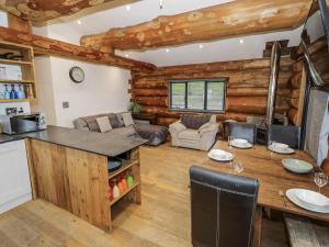a kitchen and living room in a log cabin at Douglas Cabin at Salford Court Farm Fishing Cabins in Worcester
