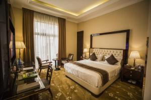 a hotel room with a large bed and a window at Sapphire Addis in Addis Ababa +61 photos