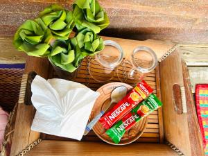 a wooden box with food and drinks and a plant at Whatsup pai in Pai