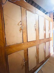 a wooden cabinet withjar doors in a room at Whatsup pai in Pai