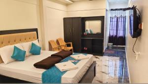 a room with a bed and a television in it at RCH Home Stay in Rāmeswaram