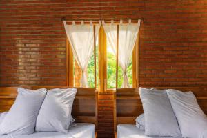 a bedroom with two beds and a window at Dream Hill Homestay in Cat Tien