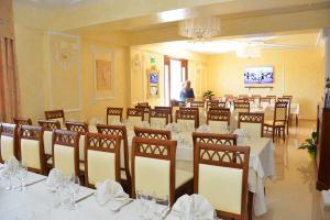 a dining room with tables and chairs with white table cloth at La Fortezza in Ariano Irpino