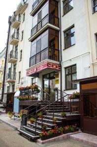 a building with stairs in front of a store at Osobnyak na Teatralnoy in Kazan