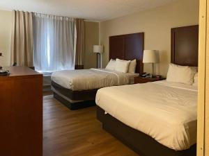 a hotel room with two beds and a window at Comfort Inn & Suites Phoenix North - Deer Valley in Phoenix +23 photos