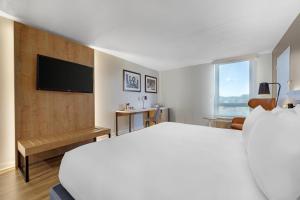 a hotel room with a bed and a flat screen tv at Radisson Hotel Philadelphia Northeast in Trevose
