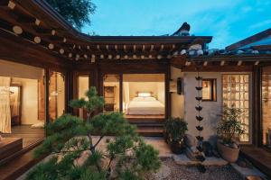 a bedroom in a house with a bed in it at THE CHAE Premium Hanok Stay in Seoul