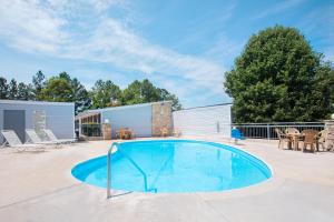 a large swimming pool in a yard with a patio at Knights Inn - Augusta in Augusta