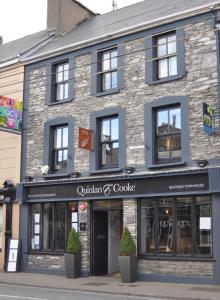 a building on the corner of a street at Quinlan & Cooke Boutique Townhouse and QCs Seafood Restaurant in Cahersiveen