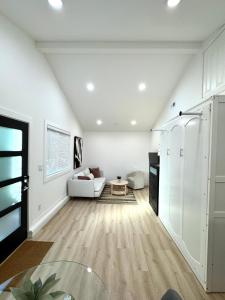 a living room with a white couch and a table at Modern and Cozy Private Studio in Lynnwood