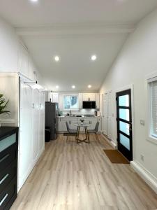 a kitchen with white cabinets and a table in it at Modern and Cozy Private Studio in Lynnwood