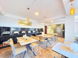 a restaurant with tables and chairs and a kitchen at Singalila Retreat by Barsana Group Darjeeling in Darjeeling