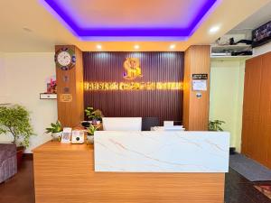 an office with a reception desk with a clock on the wall at Singalila Retreat by Barsana Group Darjeeling in Darjeeling