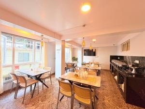 a restaurant with tables and chairs in a room at Singalila Retreat by Barsana Group Darjeeling in Darjeeling