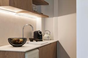 a kitchen with a sink and a bowl on a counter at Apanemo Private Suites in Akrotiri