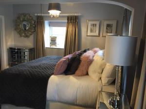 a bedroom with a bed and a table with a lamp at The Town House at Brecon in Brecon