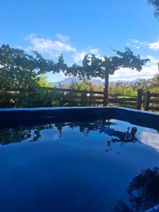 a swimming pool with a view of the mountains at 11 Mountain Stream Hot Tub Self Catering in Gordonʼs Bay