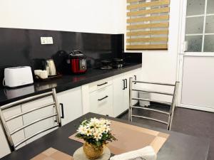 a kitchen with a table with flowers on it at Roo Ceylon Beach Villa in Matara