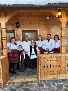 a group of people standing in front of a cabin at Acasa in Maramures in Fereşti