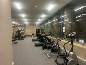 a gym with a row of treadmills and machines at 312 Mutual Heights Building in Cape Town