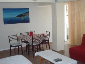 a dining room with a table and chairs at Apartments Djakonovic in Ulcinj