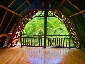 a room with a large window with a wooden floor at Triple J Villa in Sekongkang Bawa +1 photo