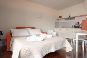 a bedroom with a white bed with towels on it at San Marco Holidays in Lucca