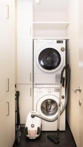 a washer and dryer in a small room at Appartement de Panne zeedijk in De Panne