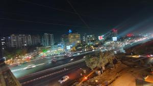 a city at night with traffic on a street at Hotel shree Tapovan in Ahmedabad