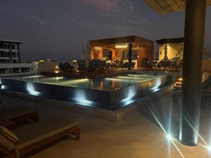 a swimming pool with lights on a roof at night at Pavilion 307 in Puerto Vallarta