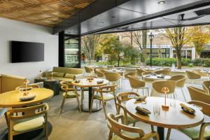 a restaurant with tables and chairs at Hyatt Regency - Greenville in Greenville
